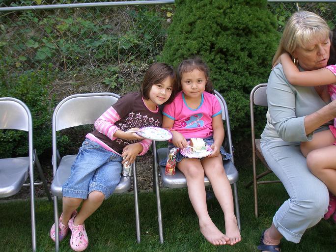 with friend Bianca,  Aunt Jan Stump and sister Sam on her lap